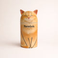 Personalized ceramic cat urn with closed eyes and warm orange glaze