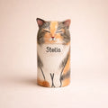 Personalized ceramic calico cat urn with closed eyes and name inscription