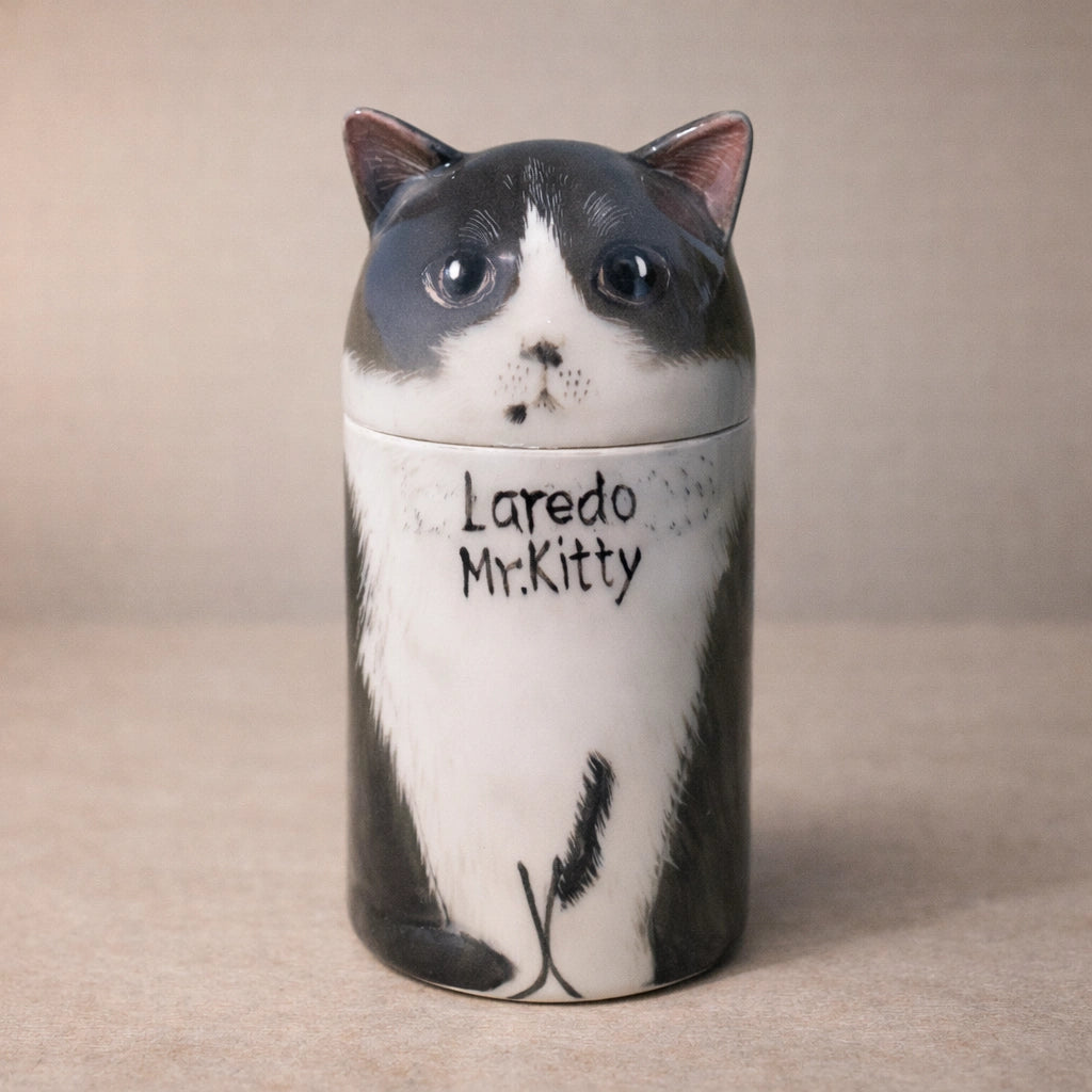 Personalized ceramic cat urn with black and white sculpted feline form