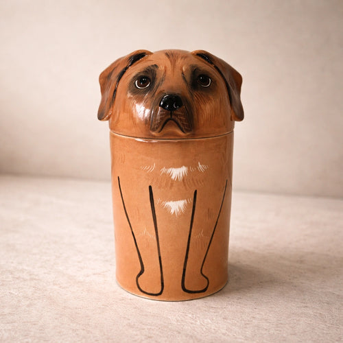 Handcrafted ceramic dog urn with warm brown glaze on neutral background