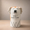 Personalized ceramic dog urn with closed eyes and name inscription