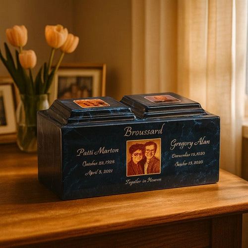 Custom urn with engraved names and photos, placed on a wooden table with flowers and framed pictures